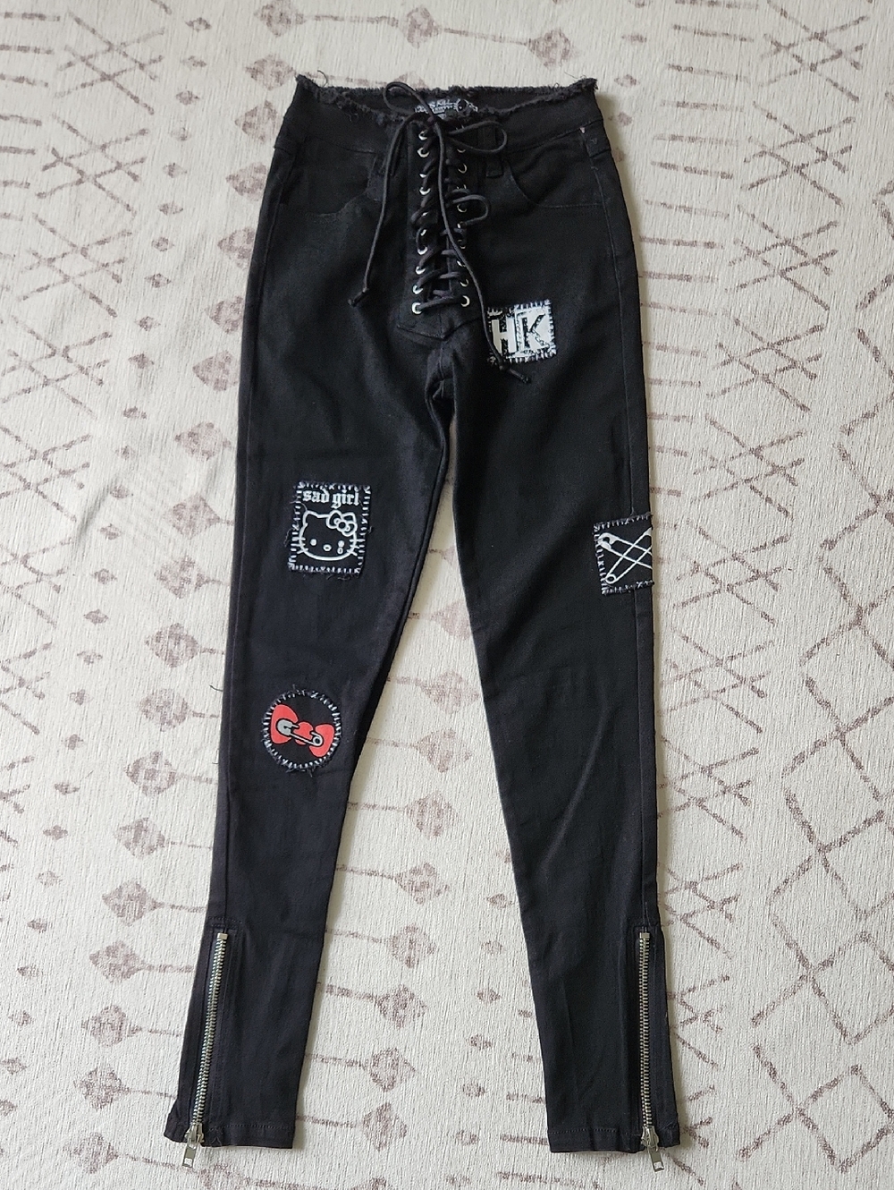 Dolls Kill x Hello Kitty Hostile Heart Patchwork Pants Lace-Up Skinny Jeans